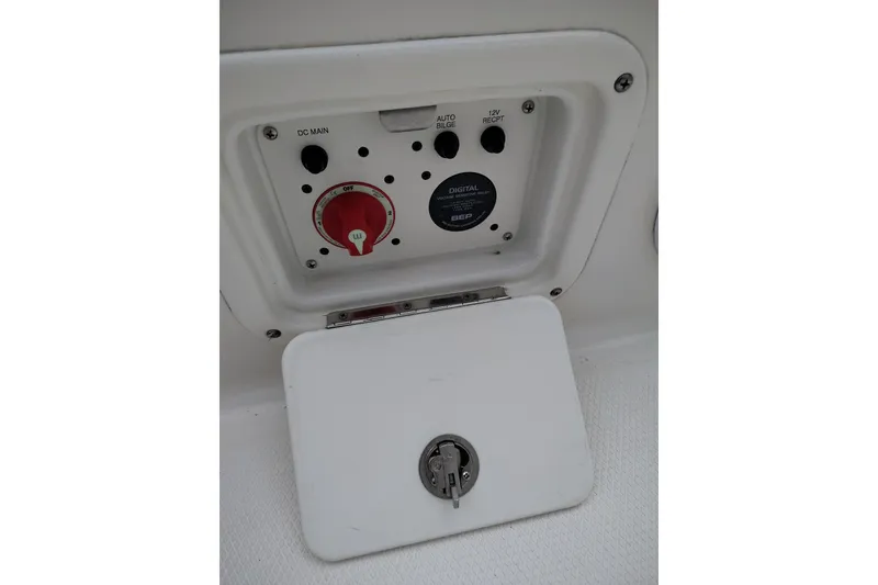 Slide: The Image of Control panel of 2021 Robalo 226 Cayman boat with switches and key lock. - 21