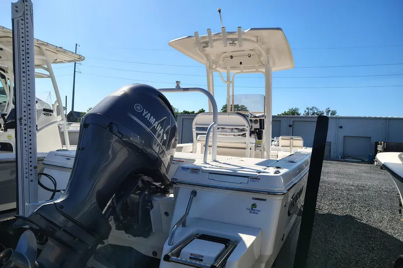 Slide: The Image of 2021 Robalo 226 Cayman boat with Yamaha outboard motor in a marina setting. - 4