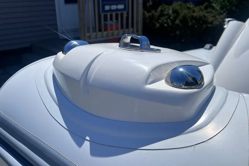 Slide: The Image of Close-up of 2016 Brig Eagle 340 boat's sleek white bow with chrome details. - 13