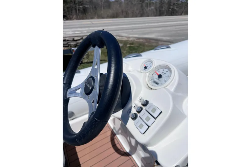 Slide: The Image of Steering wheel and dashboard of 2016 Brig Eagle 340 boat, featuring gauges and controls. - 14