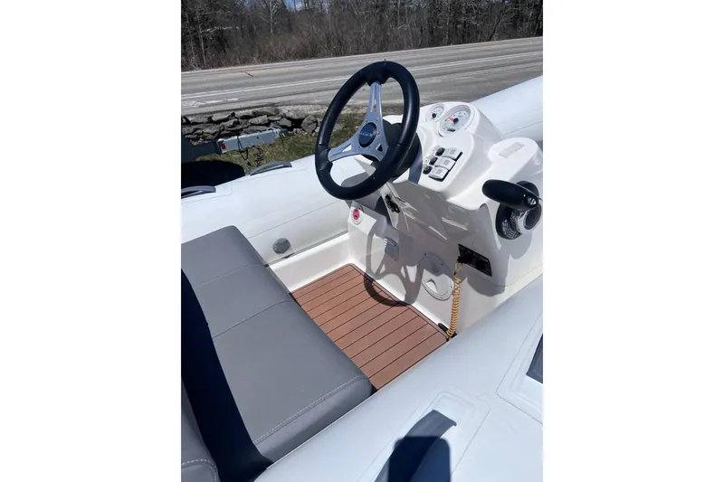 Slide: The Image of 2016 Brig Eagle 340 boat interior with steering wheel and control panel. - 16