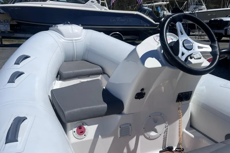 Slide: The Image of 2016 Brig Eagle 340 inflatable boat interior with steering wheel and seating. - 3