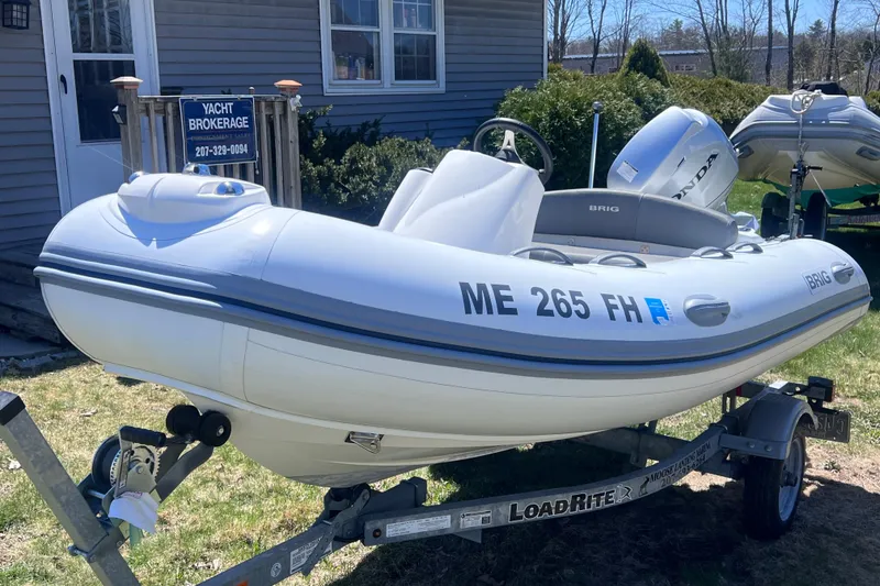 Slide: The Image of 2016 Brig Eagle 340 inflatable boat on trailer, parked outside yacht brokerage. - 5