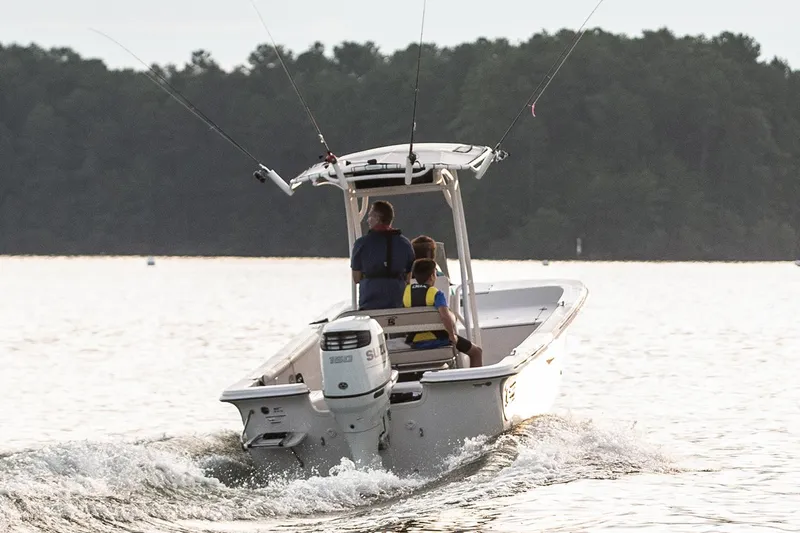 Slide: The Image of Manufacturer Provided Image: 2026 Carolina Skiff 21 LS boat on water, two people onboard, fishing rods visible. - 8