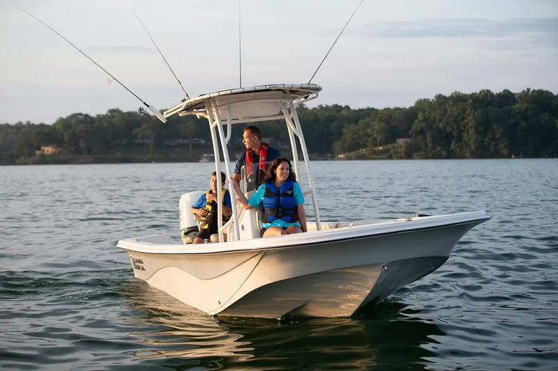 Slide: The Image of Manufacturer Provided Image: 2026 Carolina Skiff 21 LS boat on a lake with passengers enjoying a ride. - 9