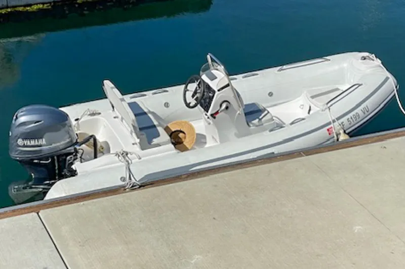 Slide: The Image of 2021 AB Inflatables Oceanus 14 VST boat docked with Yamaha outboard motor. - 2