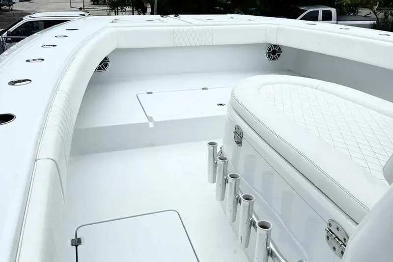 Slide: The Image of 2022 Freeman 34VH boat interior with white seating and rod holders. - 11