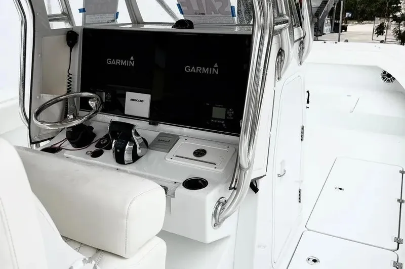 Slide: The Image of 2022 Freeman 34VH boat cockpit with Garmin navigation displays and steering wheel. - 12