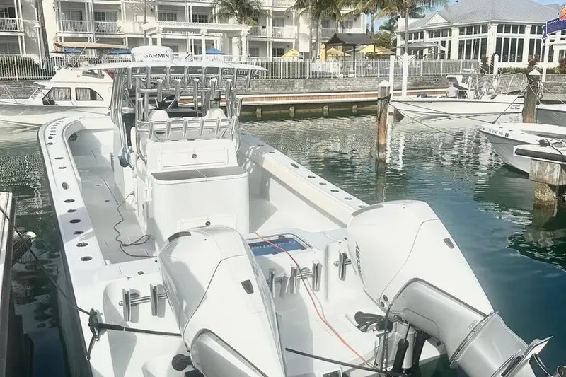 Slide: The Image of 2022 Freeman 34VH boat docked at marina with twin engines. - 14