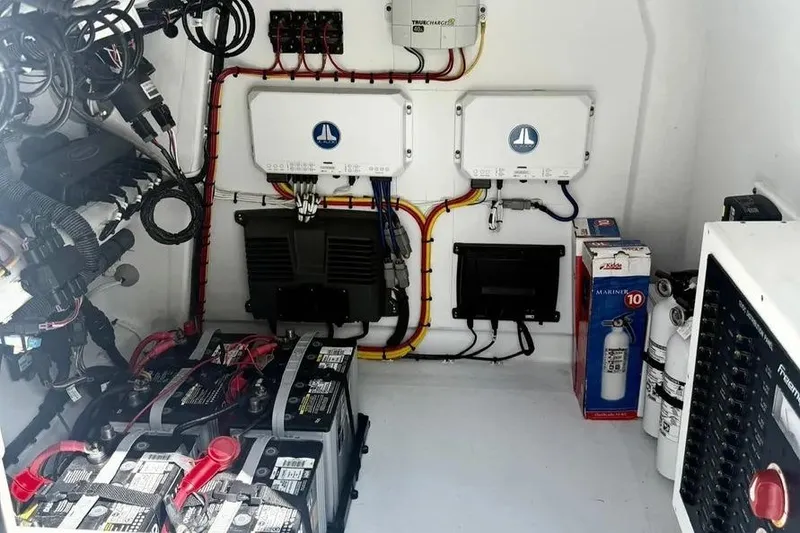 Slide: The Image of Electrical system setup in a 2022 Freeman 34VH boat, featuring batteries and wiring. - 16