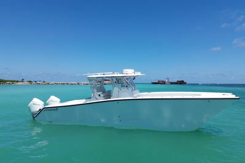 Slide: The Image of 2022 Freeman 34VH boat on turquoise water under clear blue sky. - 2