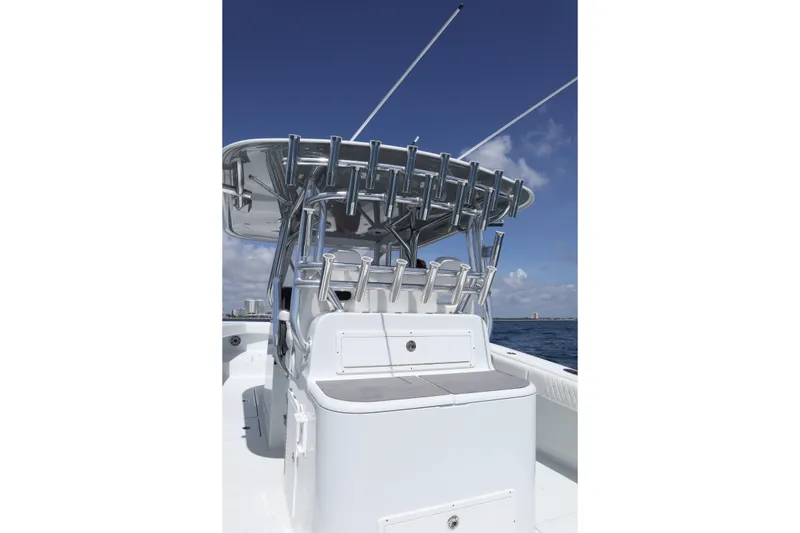 Slide: The Image of 2022 Freeman 34VH boat with rod holders, sleek design, and ocean backdrop. - 20