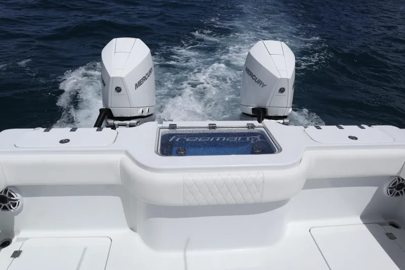 Slide: The Image of 2022 Freeman 34VH boat with dual Mercury engines on open water. - 23