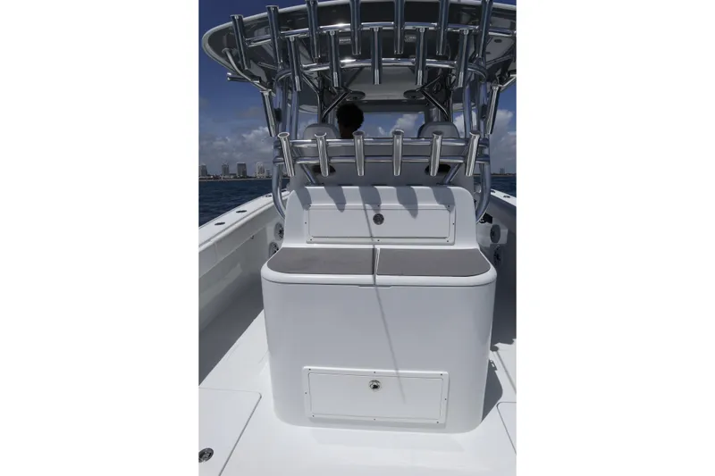 Slide: The Image of 2022 Freeman 34VH boat interior with rod holders and seating, ocean backdrop. - 24