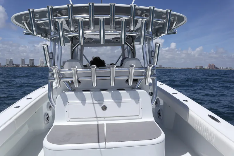 Slide: The Image of Freeman 34VH 2022 boat cruising on ocean with city skyline in background. - 25