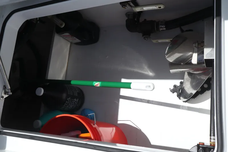 Slide: The Image of Storage compartment of a 2022 Freeman 34VH boat with cleaning supplies and equipment. - 27