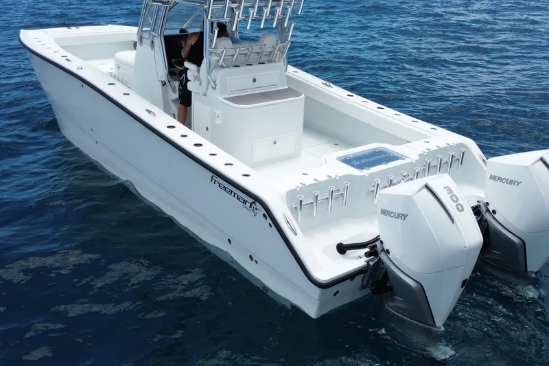 Slide: The Image of 2022 Freeman 34VH boat with dual Mercury engines on open water. - 3