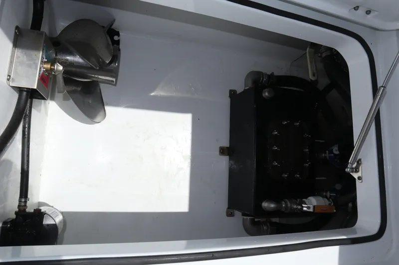 Slide: The Image of Engine compartment of a 2022 Freeman 34VH boat, featuring mechanical components and hydraulic systems. - 32