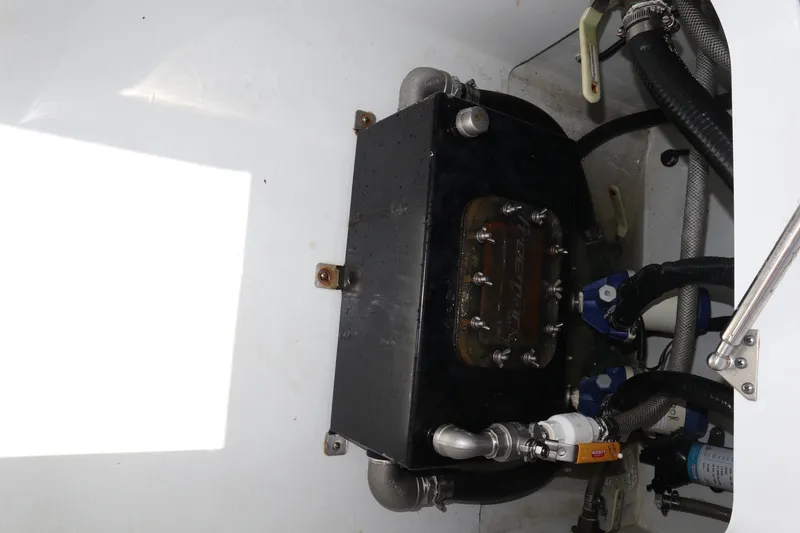 Slide: The Image of Engine compartment of a 2022 Freeman 34VH boat, featuring mechanical components and hoses. - 33