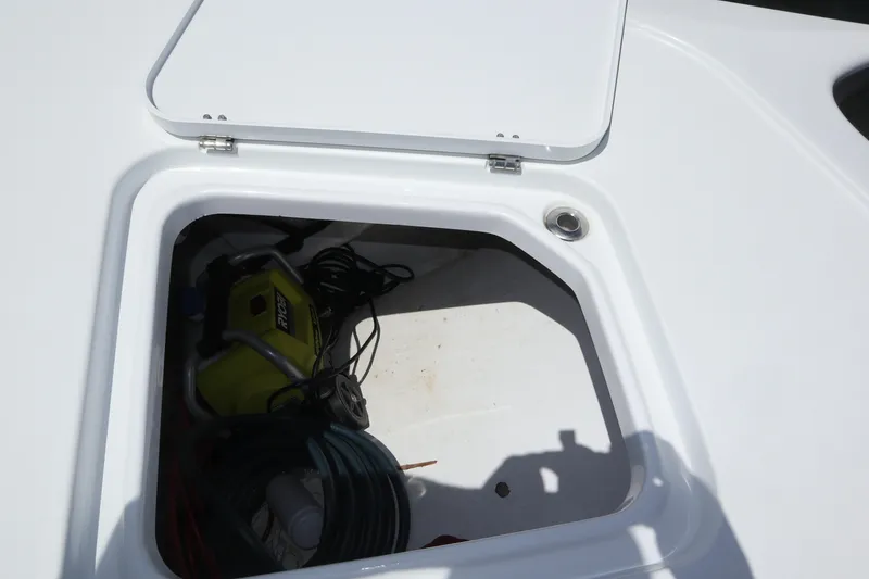 Slide: The Image of Open storage compartment on 2022 Freeman 34VH boat, containing equipment and cables. - 36