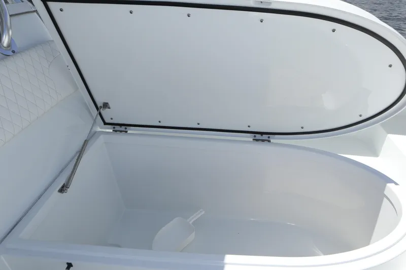 Slide: The Image of Open storage compartment on a 2022 Freeman 34VH boat, featuring a white interior. - 39
