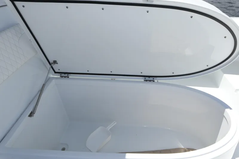 Slide: The Image of Open storage compartment on a 2022 Freeman 34VH boat, featuring a white interior. - 40
