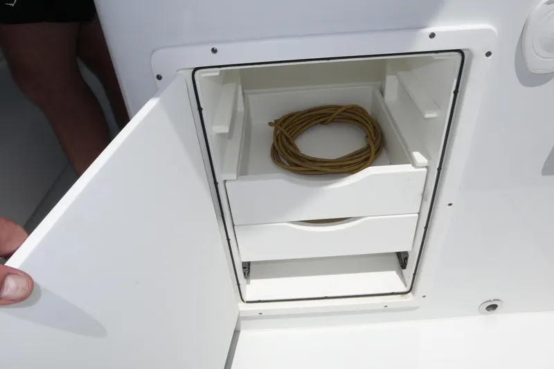 Slide: The Image of Open storage compartment on Freeman 34VH boat, showing coiled rope inside. - 44