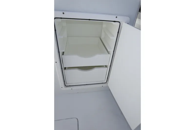 Slide: The Image of Open storage compartment with drawers on a 2022 Freeman 34VH boat. - 46