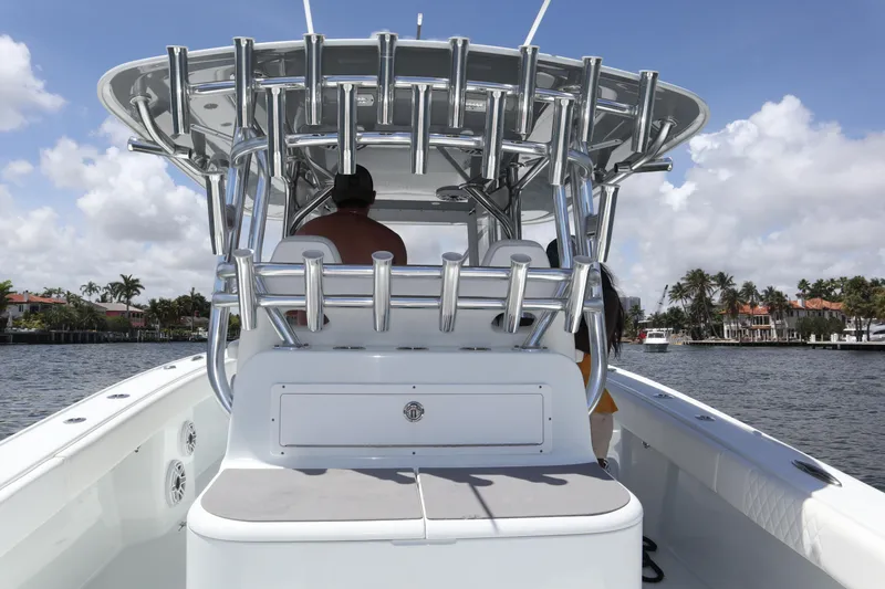 Slide: The Image of 2022 Freeman 34VH boat on water, featuring sleek design and rod holders. - 49