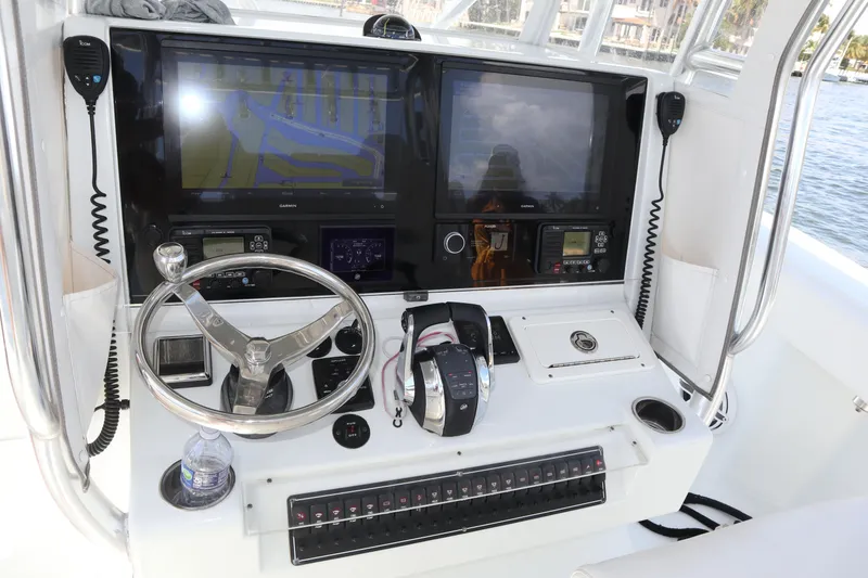 Slide: The Image of 2022 Freeman 34VH boat helm with dual screens, steering wheel, and control panel. - 50