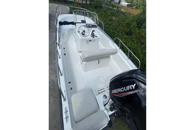 Slide: The Image of 2022 Boston Whaler 170 Montauk boat with Mercury engine, white interior, and seating. - 10