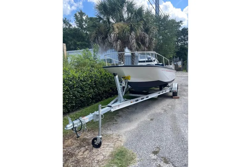 Slide: The Image of 2022 Boston Whaler 170 Montauk boat on trailer, parked outdoors. - 11