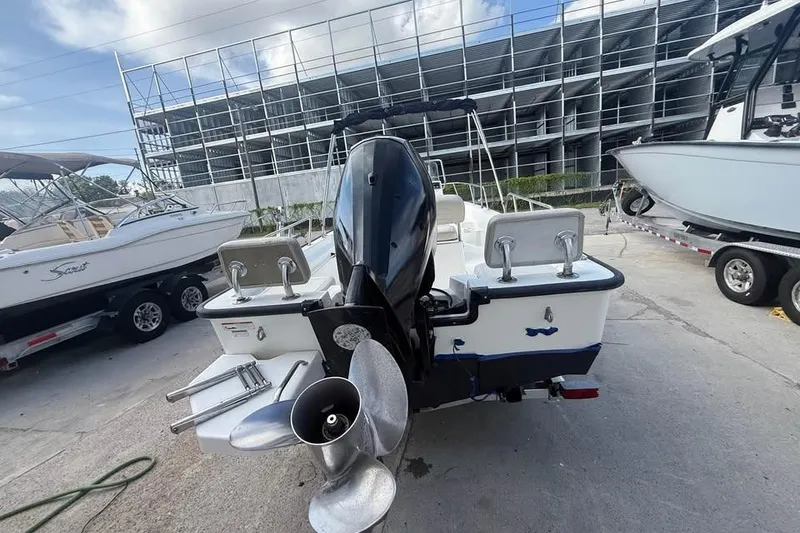 Slide: The Image of 2022 Boston Whaler 170 Montauk boat with outboard motor, parked in marina. - 13