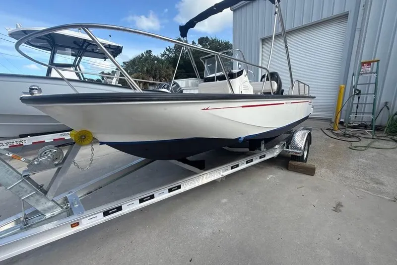 Slide: The Image of 2022 Boston Whaler 170 Montauk boat on trailer, parked outside a building. - 15