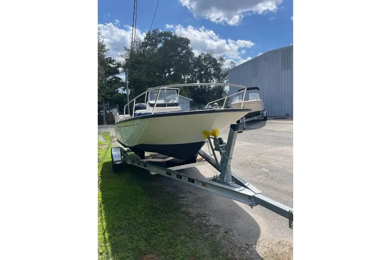 Slide: The Image of 2022 Boston Whaler 170 Montauk boat on trailer, parked outdoors. - 8