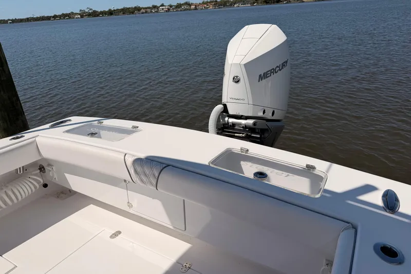 Slide: The Image of 2024 Stoner 23 CC boat with Mercury Verado engine on calm water. - 10