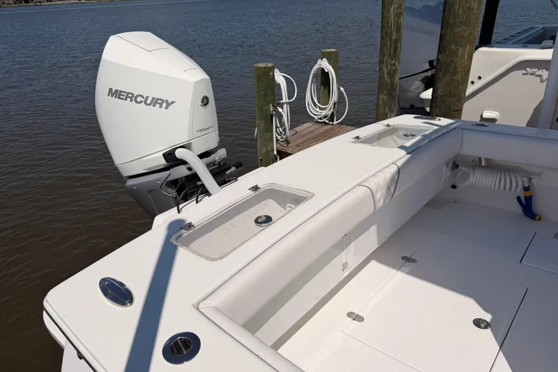 Slide: The Image of 2024 Stoner 23 CC boat with Mercury engine docked by the water. - 11