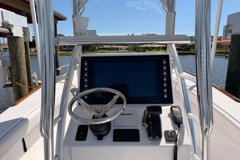 Slide: The Image of 2024 Stoner 23 CC boat console with steering wheel and navigation display. - 14