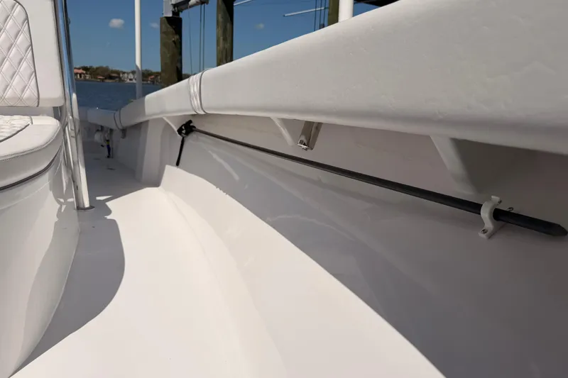 Slide: The Image of 2024 Stoner 23 CC boat interior with white seating and sleek design. - 18