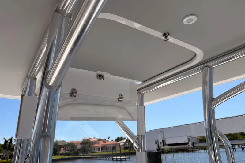 Slide: The Image of 2024 Stoner 23 CC boat interior with sleek metal framework and waterfront view. - 21