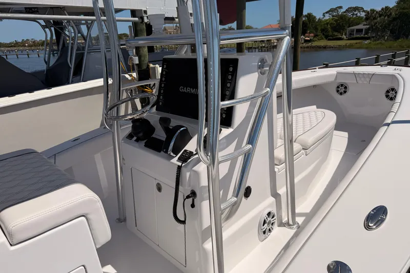 Slide: The Image of 2024 Stoner 23 CC boat interior with Garmin navigation system and sleek seating. - 24