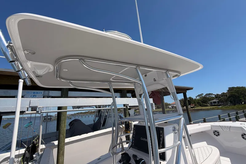 Slide: The Image of 2024 Stoner 23 CC boat with sleek T-top and modern console design. - 25