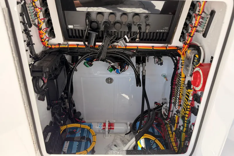 Slide: The Image of Electrical wiring and components inside a 2024 Stoner 23 CC boat. - 26