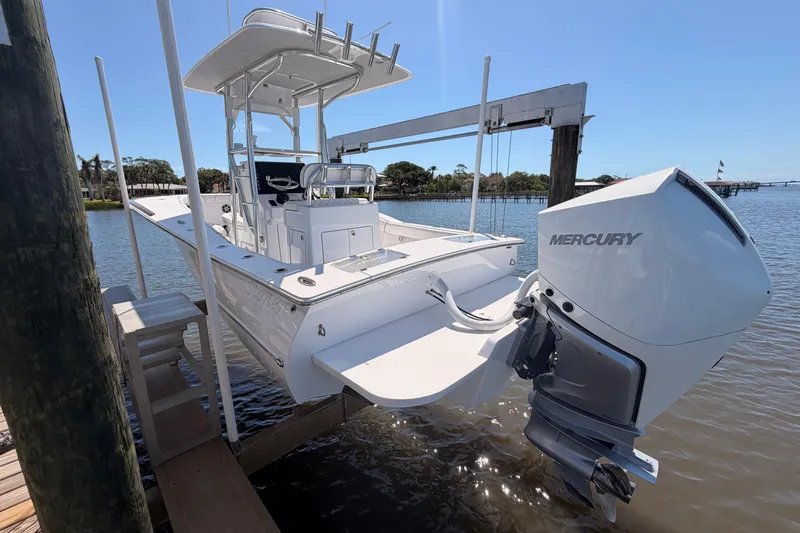 Slide: The Image of 2024 Stoner 23 CC boat with Mercury engine docked by the water. - 5