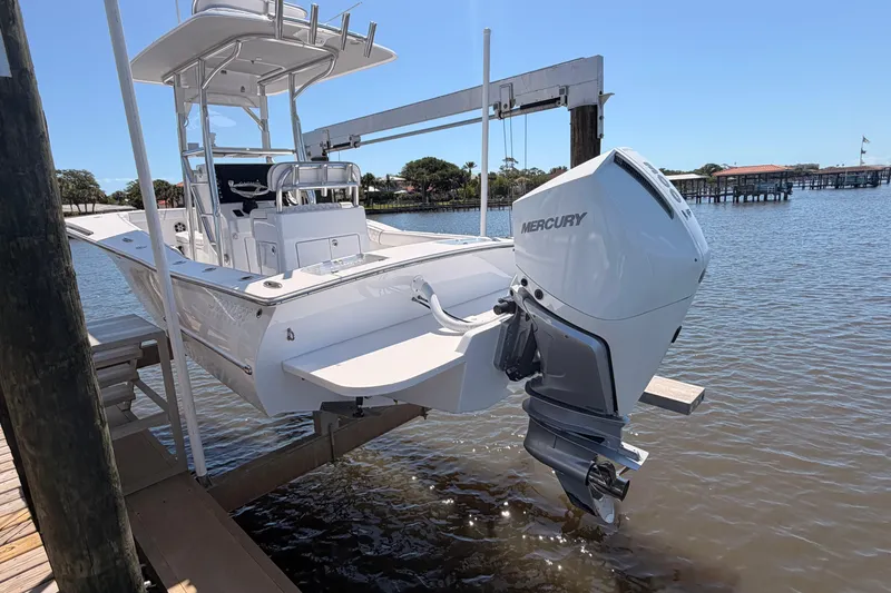 Slide: The Image of 2024 Stoner 23 CC boat with Mercury engine docked by the water. - 6