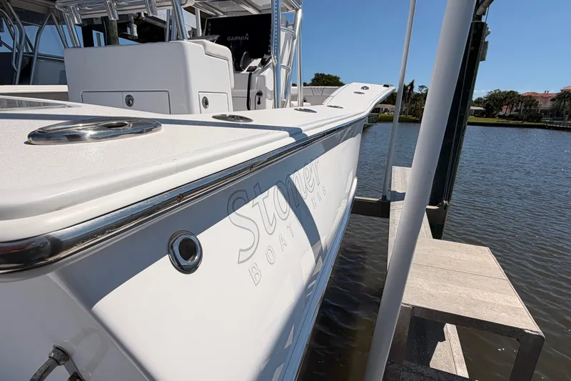 Slide: The Image of 2024 Stoner 23 CC boat docked by the water, showcasing sleek design and modern features. - 9