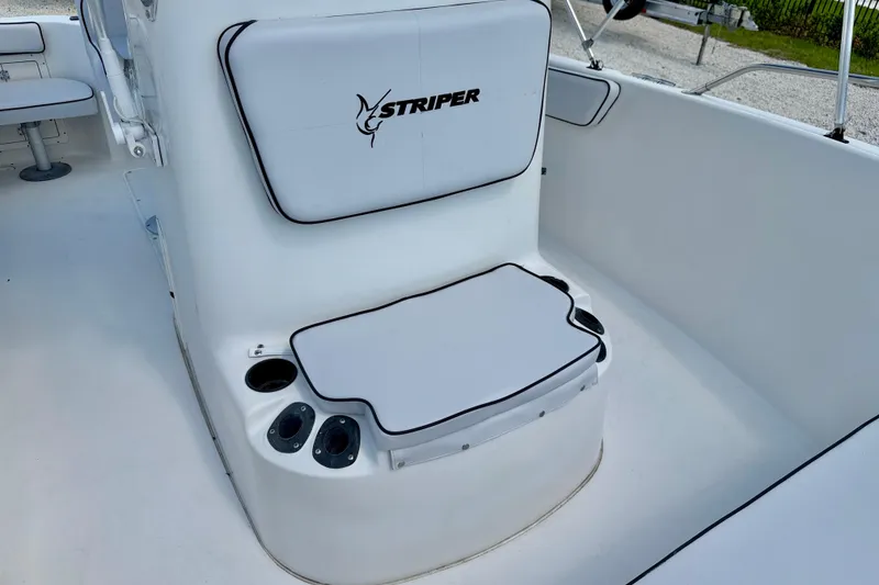 Slide: The Image of 2003 Seaswirl Striper 2101 CC boat interior with cushioned seating and cup holders. - 11