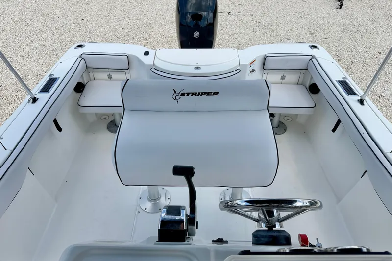Slide: The Image of 2003 Seaswirl Striper 2101 CC boat interior with steering wheel and seating. - 13