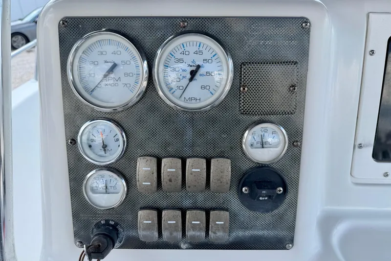 Slide: The Image of Dashboard of a 2003 Seaswirl Striper 2101 CC boat with gauges and switches. - 15