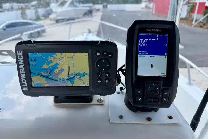 Slide: The Image of Lowrance and Garmin navigation devices on a 2003 Seaswirl Striper 2101 CC boat dashboard. - 16